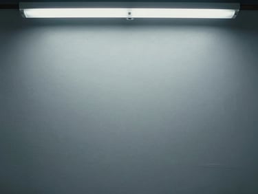 Close-up straight-on shot of a spray-painted flat commercial surface showing perfectly uniform matte coverage with no visible lap lines or texture variation, cool overhead fluorescent light, paint filling the frame edge to edge