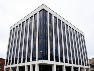 Wide architectural shot of the Hughes Security Engineering LLC office building in Williamsburg, Virginia, modern, secure, professional, crisp technical photography, sharp overcast daylight, deep navy and stark white tones, high contrast, architectural lens, no people