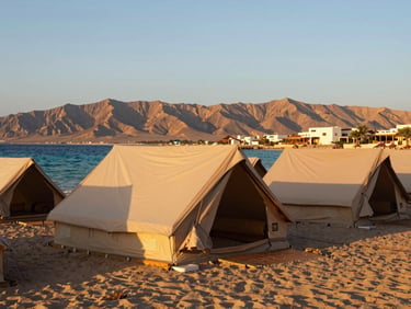 bright editorial travel photography, warm golden-hour sunlight, rich natural colors, high contrast, 35mm lens, cozy beach camp and resort style in Dahab with mountains and blue sea