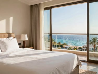 Premium hotel room interior in Hurghada, clean white linens, balcony overlooking the Red Sea, bright daylight