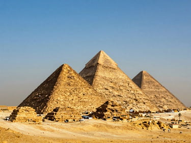 The Great Pyramids of Giza under a clear blue sky, warm golden sunlight, wide environmental shot.