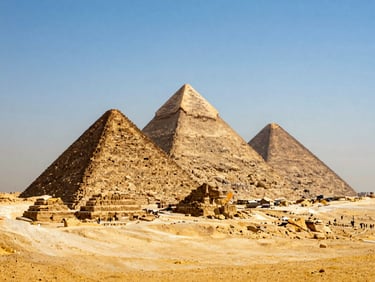 Wide environmental shot of the Great Pyramids of Giza under a clear blue sky, warm natural daylight, majestic desert landscape