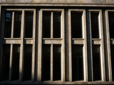 Architectural lines of the Metro courthouse, dramatic low-key window light, deep blacks, editorial photography