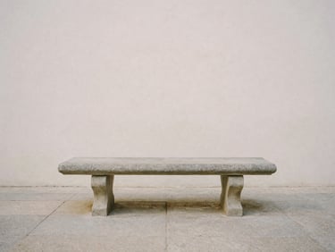 A solitary stone bench in a quiet classical courtyard, soft morning mist, minimalist composition, contemplative atmosphere