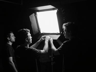 Focused crew member adjusting a large LED light on a dark soundstage, high-contrast monochrome, sharp neon practical lights, cinematic film photography