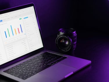 Sleek dark-mode workspace close-up, dramatic purple neon rim lighting casting deep shadows over an open laptop showing clean analytics dashboards, 35mm lens