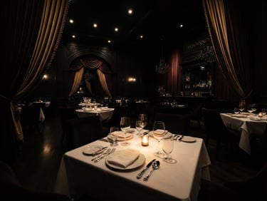 Dramatic wide-angle shot of Yovanni's opulent, dimly lit dining room with velvet drapes and strong directional spotlights, empty tables awaiting guests, chiaroscuro lighting.