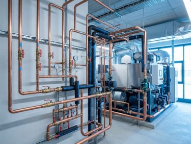 Clean commercial photography of modern copper piping and technical HVAC equipment, bright daylight, crisp cool blue tones, sharp focus, 35mm