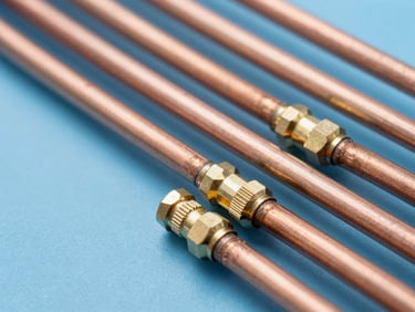 Macro shot of clean copper refrigeration lines with brass fittings, technical precision, utility lighting
