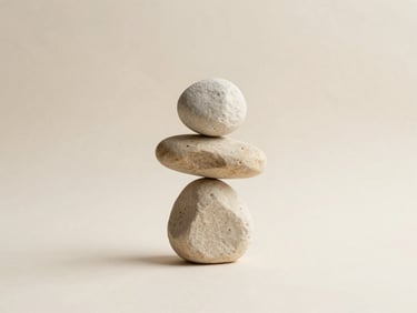 Minimalist clean composition of balanced stone sculpture on a warm cream background, soft overcast daylight shadow, 35mm photography