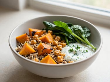 A colorful bowl of quinoa, roasted pumpkin, chickpeas, and fresh spinach with a light herb dressing, daylight