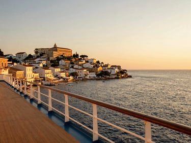 Classic Mediterranean coastal town viewed from a cruise ship deck at sunset, warm golden-hour light, premium travel aesthetic
