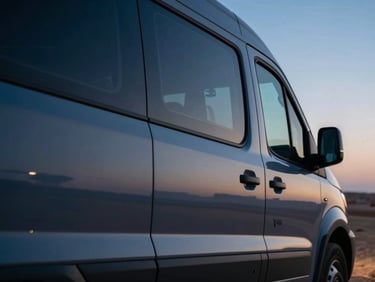 Close-up of a modern commercial transport vehicle reflecting sharp desert twilight light, clean metallic details, 35mm
