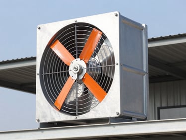 Close-up of a heavy-duty industrial roof fan with aluminum casing, installed on a metal roof under clear sky, professional product photography