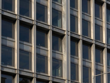 Editorial architectural photography of structured steel and glass joints, sharp focus, neutral tones, crisp natural daylight, 35mm