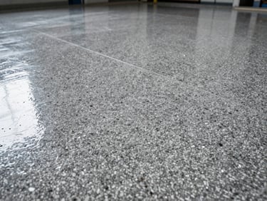 Close-up of a highly durable quartz epoxy floor, dense colored quartz grains visible under a clear protective layer, industrial setting