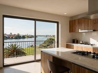 Images/propiedades/depto_san_pedro.jpg: Bright sunlit apartment interior in San Pedro de la Paz, clean balcony with river views, modern kitchen counter, warm daylight.