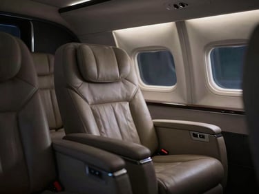 Interior detail of a luxury passenger cabin, premium leather seating, ambient low-key lighting, minimalist design.