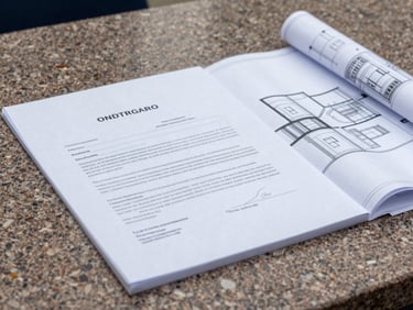Close-up of signed legal contracts and architectural blueprints on a travertine table, natural overcast light, sharp focus