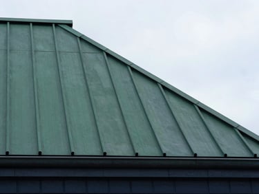 Crisp architectural detail of dark green metal roof seams on a renovated building, Riga, sharp focus
