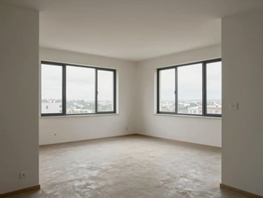 Wide environmental shot of a two-bedroom apartment from the living room doorway, overcast daylight through large windows, pale walls and clean floors, empty and architectural