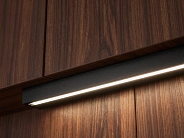 Extreme close-up of a sleek black aluminum LED profile recessed into dark walnut wood paneling, crisp warm light illuminating the rich wood grain, architectural detail, premium lighting design.