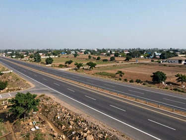 Wide commercial land parcel facing a newly paved multi-lane highway in Dholera.