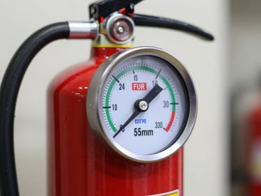 A close-up technical shot of a certified red fire extinguisher pressure gauge showing green zone, crisp industrial lighting, professional engineering focus, 35mm lens