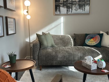 Warm, inviting therapy room with a prompt to book a free 20-min consult at Tri Lotus Psychotherapy