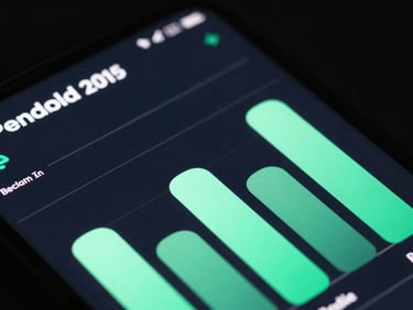 Extreme close-up of a premium Android device displaying a dark slate fintech interface with vibrant mint green charts, sharp typography, low-key studio lighting