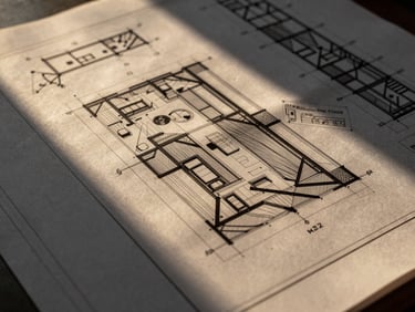 Close-up of technical architectural blueprints overlaying a digital BIM model on a screen, high-contrast charcoal tones