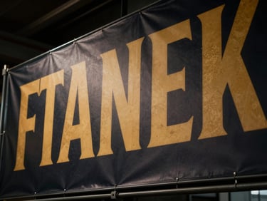 Close-up of a large format banner material, subtle texture, vibrant printed graphics, low-key moody lighting, warm gold highlights, 35mm lens, industrial discipline.