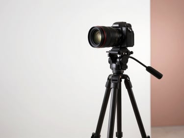 Minimalist studio setup with a camera on a tripod, soft diffused lighting, white and rose gold background accents, clean composition.