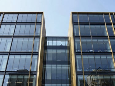 Symmetrical modern office building facade with clean glass panels, bright morning daylight, architectural structure, corporate editorial style, 35mm