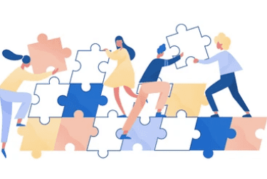 people are standing around a puzzle piece of puzzle pieces