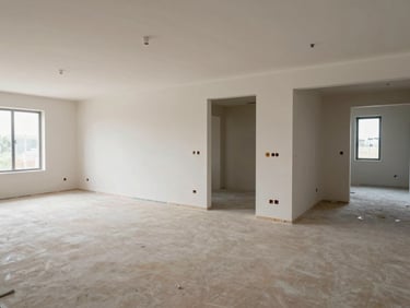 Wide environmental shot of a finished construction site showing completed rooms with tile, painted walls and installed fixtures, north-facing light, no people posing