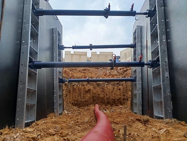 XpressJack quick shoring system supporting a trench during pipe and cable laying installation.