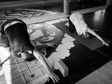 People performing thread the needle pose for shoulder tension.