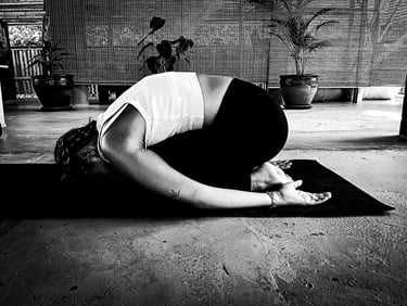 A woman practising yoga - Child Pose
