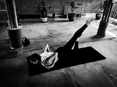 A woman practising a variant of Locust Pose a during yoga class