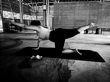a woman practising Balancing Table  yoga poses on a mat