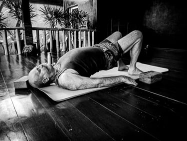 A man practices yoga for Spine & Hip Strength at Santoshayog residency in Siem Reap