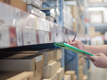a person holding a clipboard in a warehouse