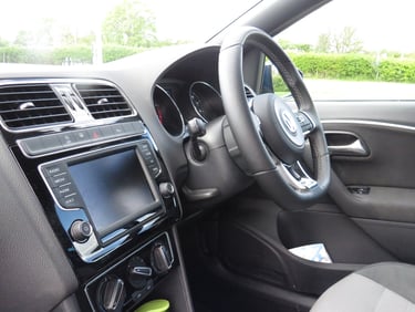 a car dashboard with a steering wheel and dashboard controls