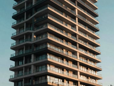 Exterior of a premium modern residential high-rise building in Baku, sleek steel and concrete balconies, evening light