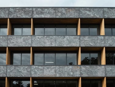 Architectural detail of a modern research institution's facade, cool clinical daylight, sharp focus, desaturated slate and amber tones, 35mm