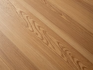 Top-down detail of warm European oak SPC planks, showing realistic wood grain texture under soft diffused light.