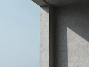 Minimalist architectural detail of a concrete column with soft overcast daylight casting long shadows, muted blue tones, clean composition, 35mm.