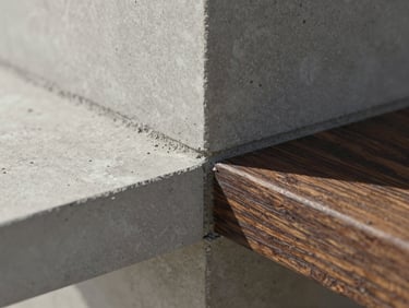 Macro close-up of a concrete and dark timber join, sharp architectural daylight, showing raw texture and structural precision