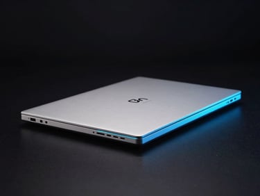 Thin, lightweight silver laptop from a slightly elevated angle, showcasing its slim profile, on a dark, reflective surface, neon-lit hardware photography, deep obsidian background, electric cyan and blue rim lighting, macro lens, high contrast, 35mm
